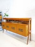 Stunning Italian credenza in cherrywood
In the style of Gio Ponti and Paolo Buffa pieces of this period.
Elegant highly shaped legs
Copper plate relief panels in each door depicting epicurean motifs.
Fully restored
A rare and wonderful piece