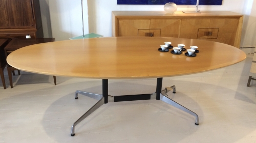 Oval blonde wood table with Eames Aluminium Group base.